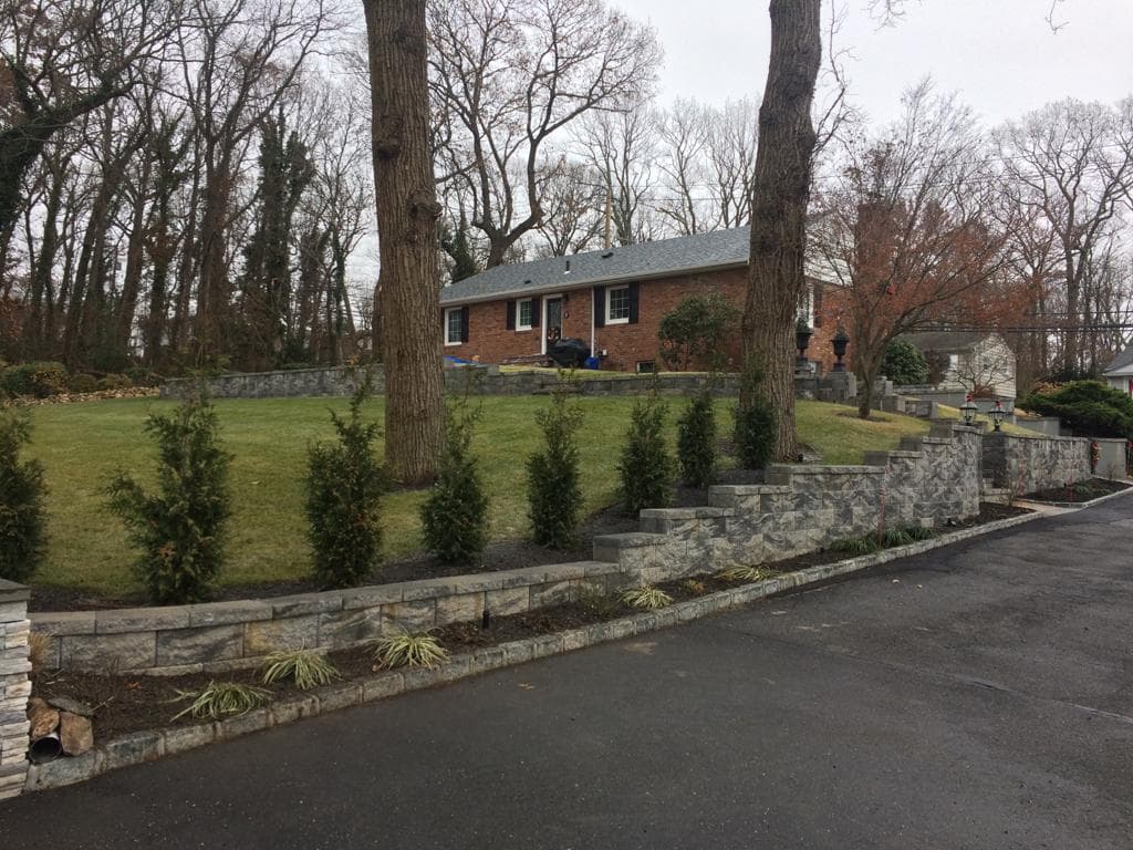 Stone Retaining Wall and Steps Built for a Sloped Front Yard image